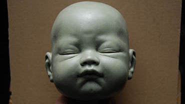 Wax head sculpture with closed eyes