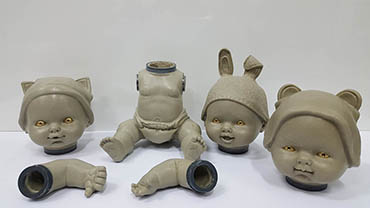 Schematic wax sculpture with three different heads